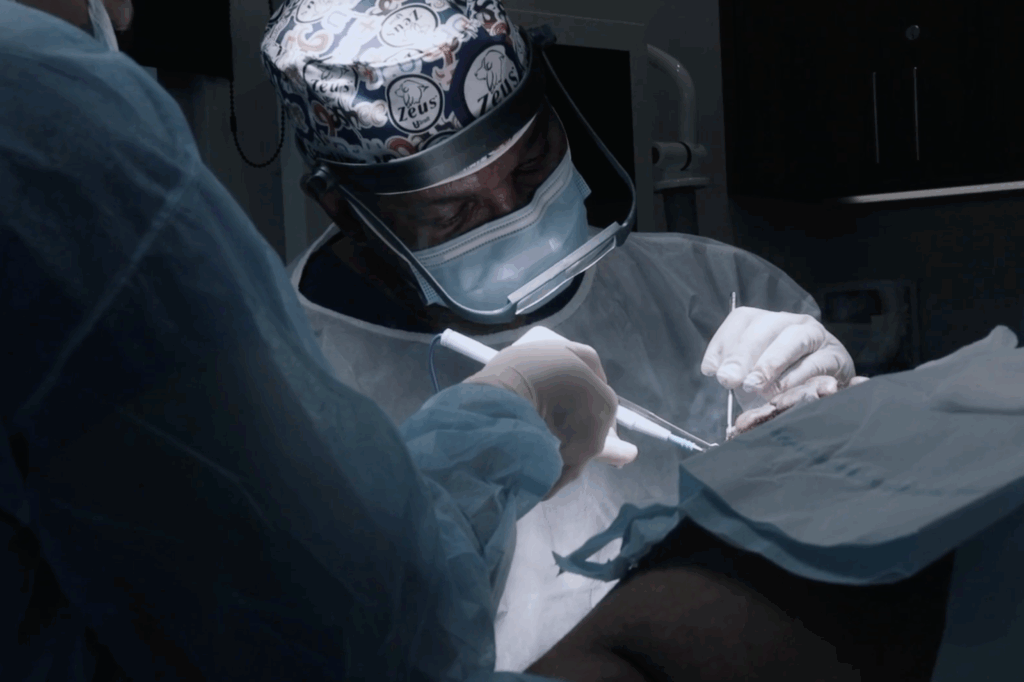 Dr. Umar performs the removal of the diseased tissue.