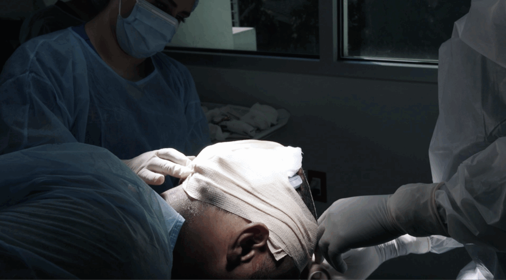 Dr. Umar wraps up the surgical site on Anwar’s scalp after a successful surgery.