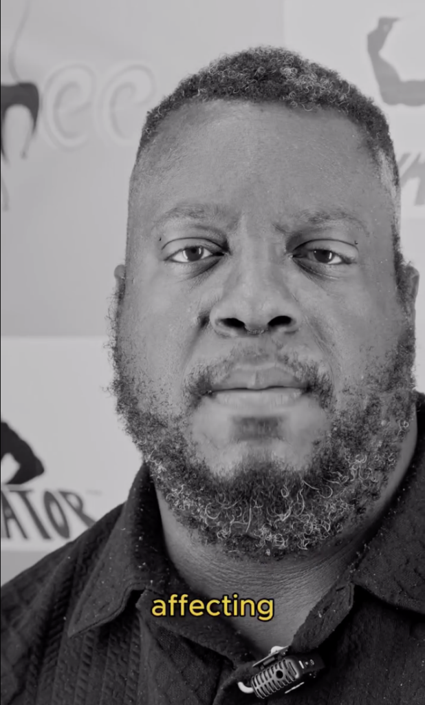 Black-and-white close-up of Pastor Chalmers speaking to camera.