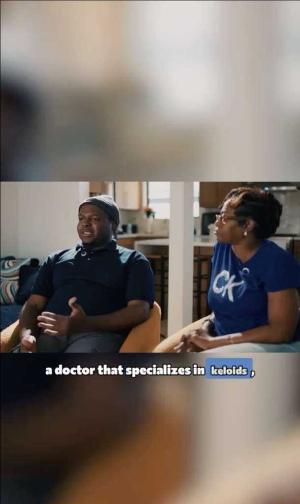 Marcus seated beside a woman during an interview, with on-screen text about a doctor who specializes in keloids.